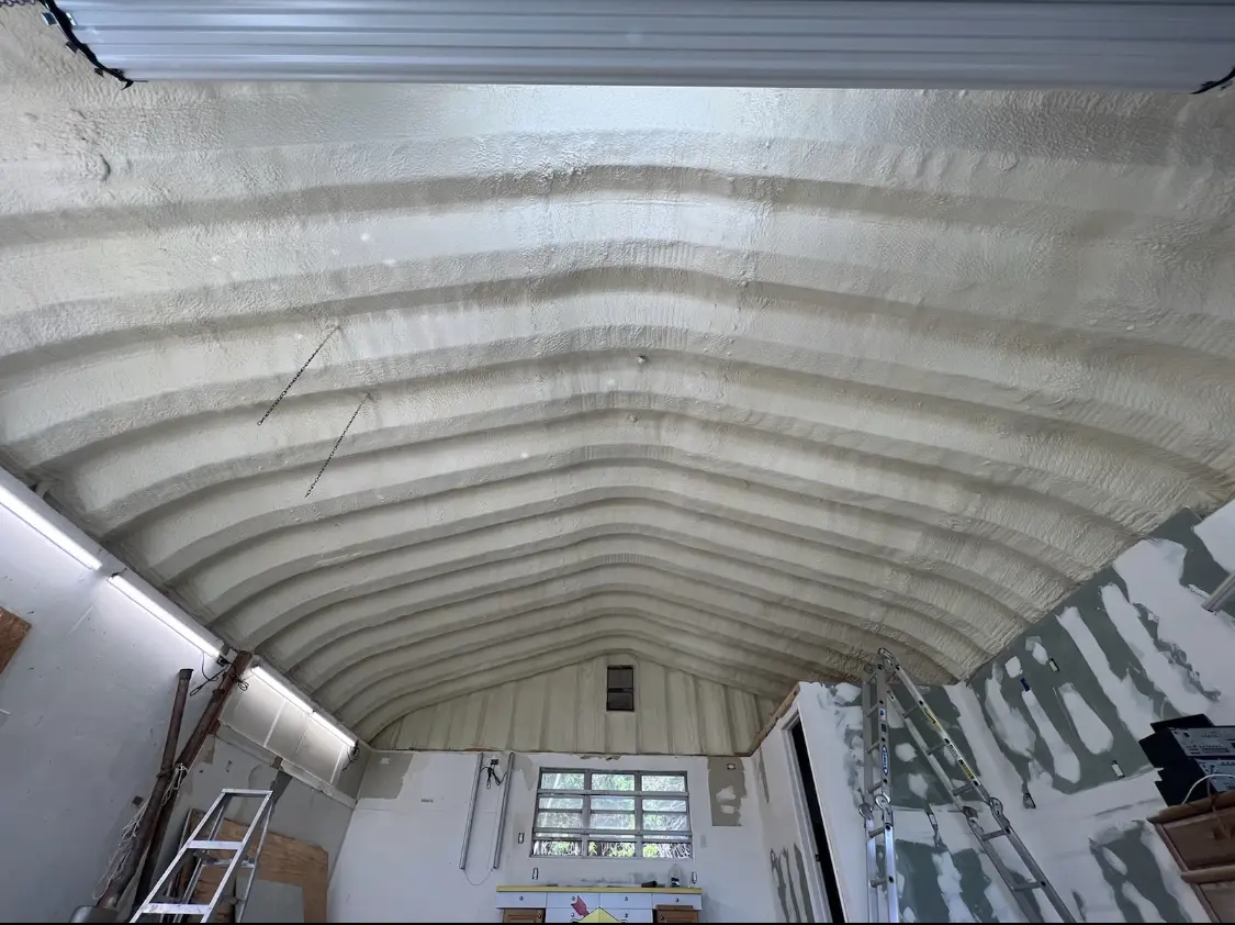 Spray polyurethane foam applied to the underside of a metal roof deck in Cold Springs